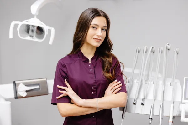Emergency dentist in Stuart standing in a modern dental clinic beside a dental chair and treatment tools, ready to provide urgent care.