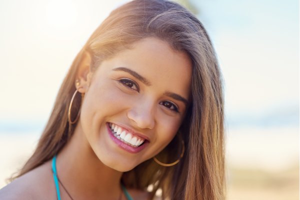 Smiling woman showing bright white teeth, representing results from teeth whitening in Stuart for a more confident smile